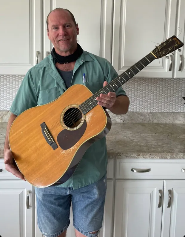 The original owner's grandson holding the family's 1946 Martin D-28
