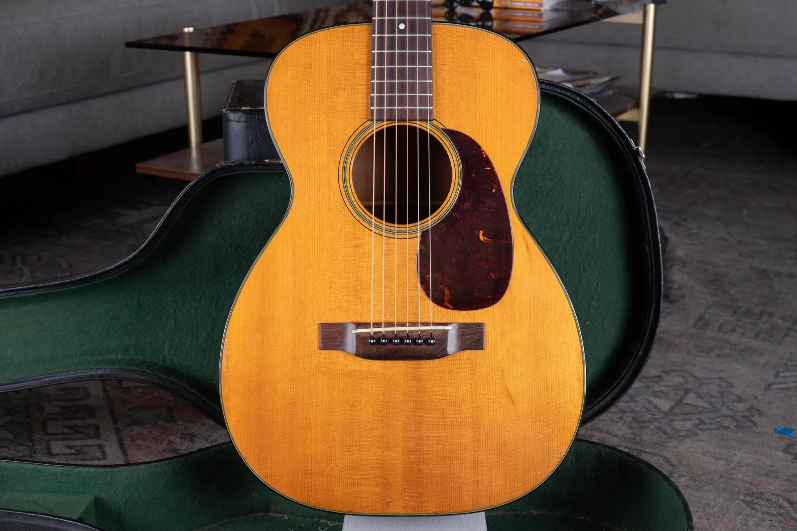 Front of Linda Gayle's natural 1949 Martin 0-18 resting in a green-lined case