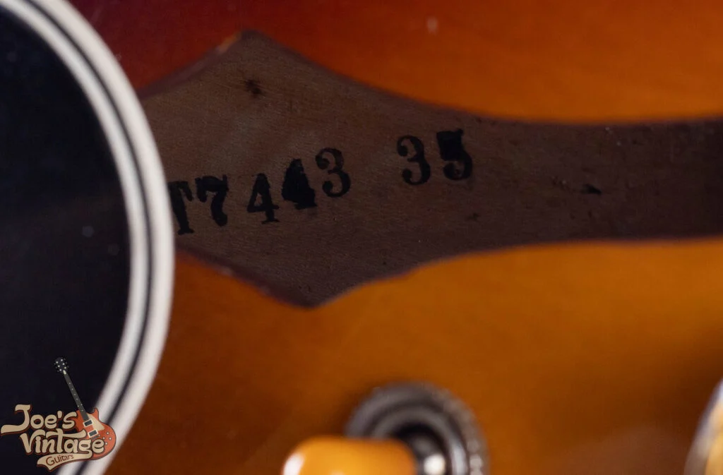 T-prefix Factory Order Number stamped directly onto bare wood inside a sunburst ES-335