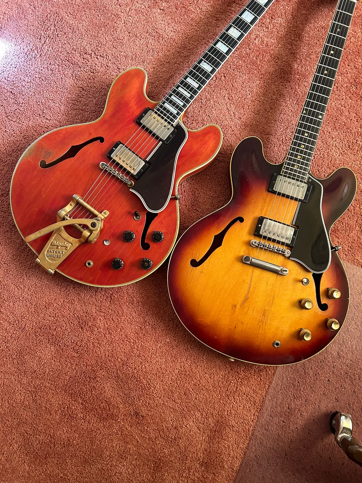 Cherry 1959 Gibson ES-355 with Bigsby beside a sunburst Gibson ES-335