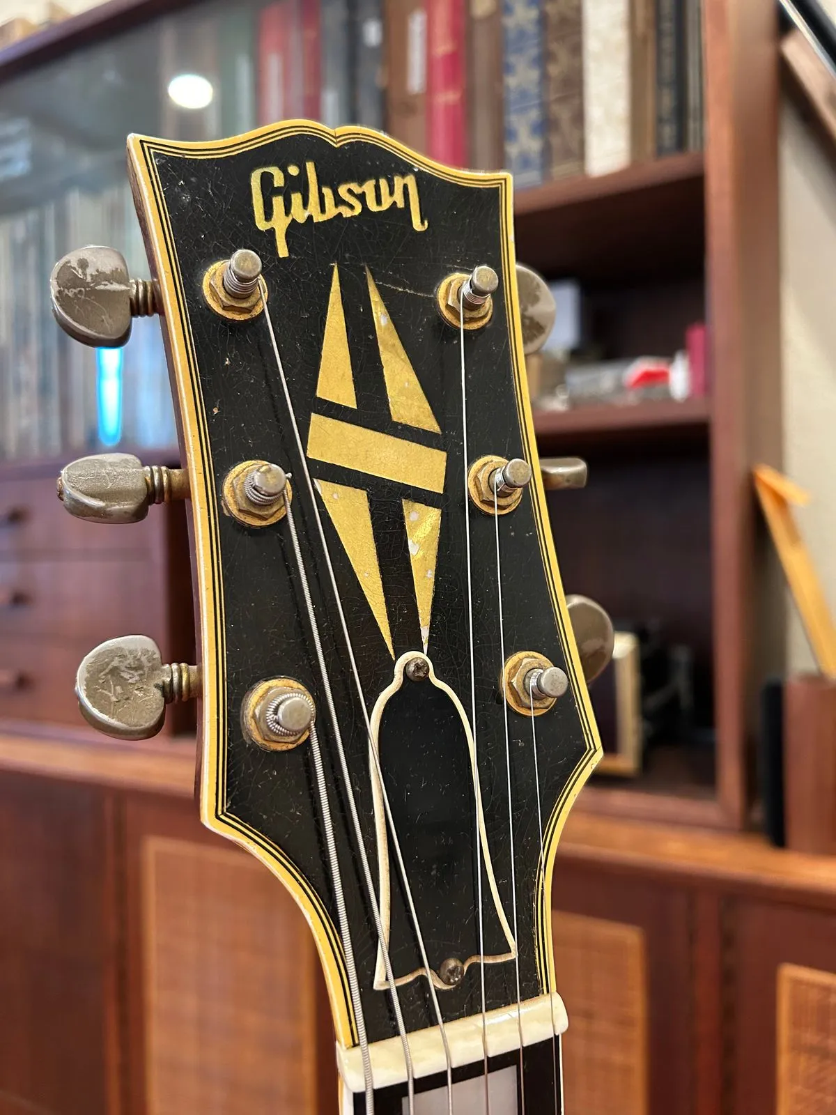 Bound black Gibson ES-355 headstock with split-diamond inlay and worn gold tuners