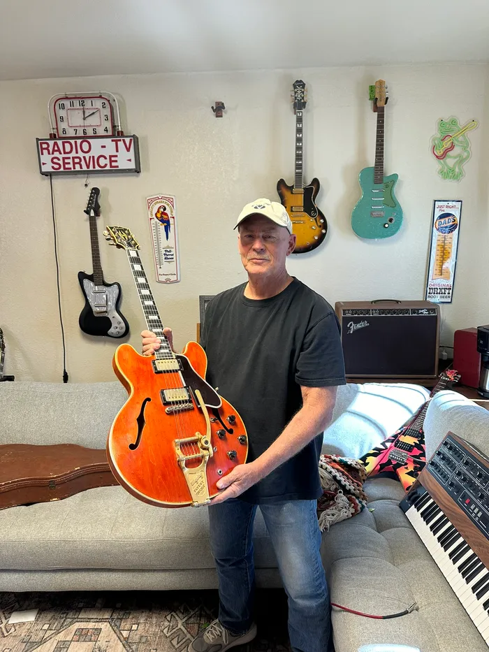 The original owner's son holding the family's cherry 1959 Gibson ES-355