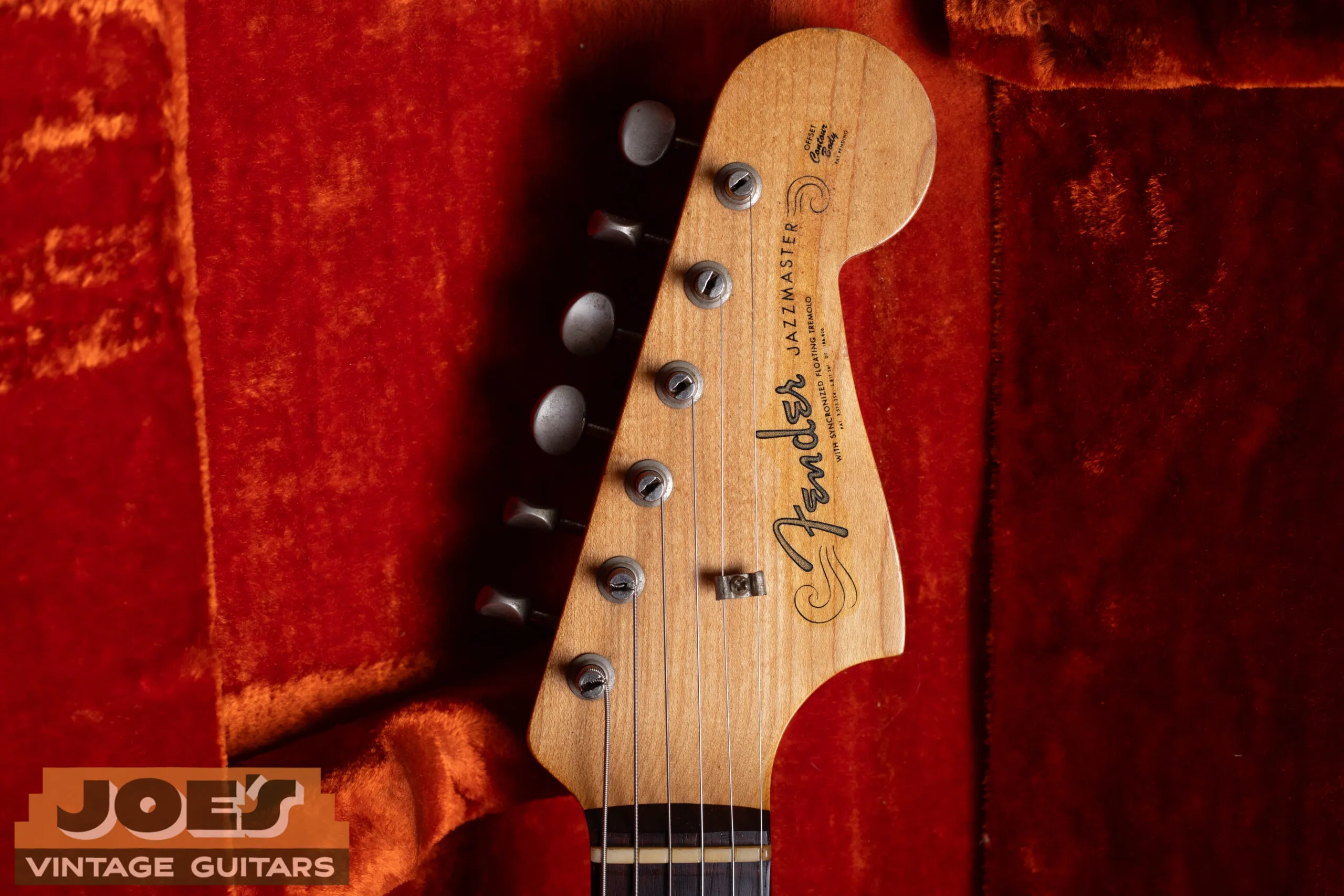 1960s Fender Jazzmaster headstock with spaghetti logo, pre-CBS thin flowing cursive Fender script in silver chrome, clay dot fingerboard, single-line Kluson tuners