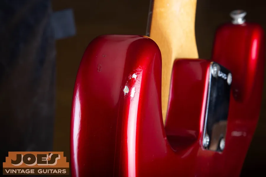 Finish chip on a 1965 Candy Apple Red Fender Stratocaster revealing the silver undercoat