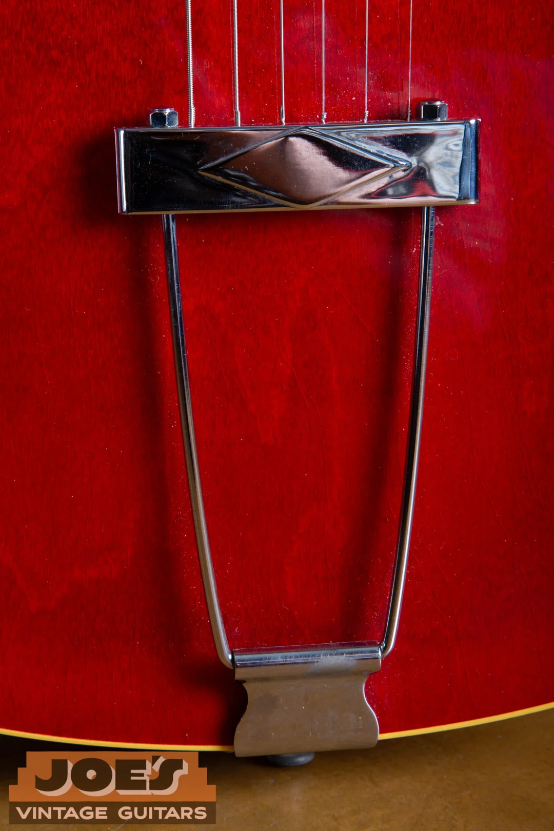 Chrome trapeze tailpiece mounted at the end of a cherry 1966 Gibson ES-335