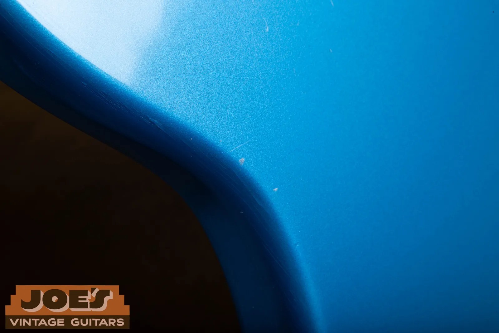 Close view of the metallic Lake Placid Blue finish along the edge of Bill's 1966 Jaguar