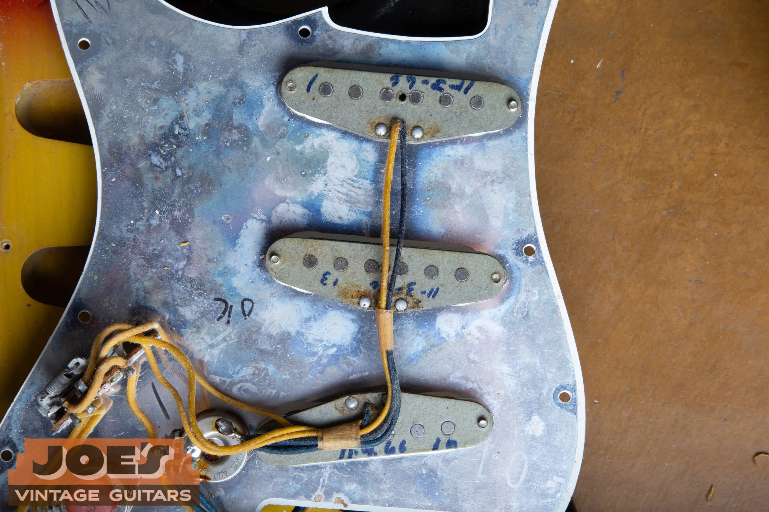 Gray-bottom 1966 Stratocaster pickup with the winder’s date written on the bobbin in blue marker