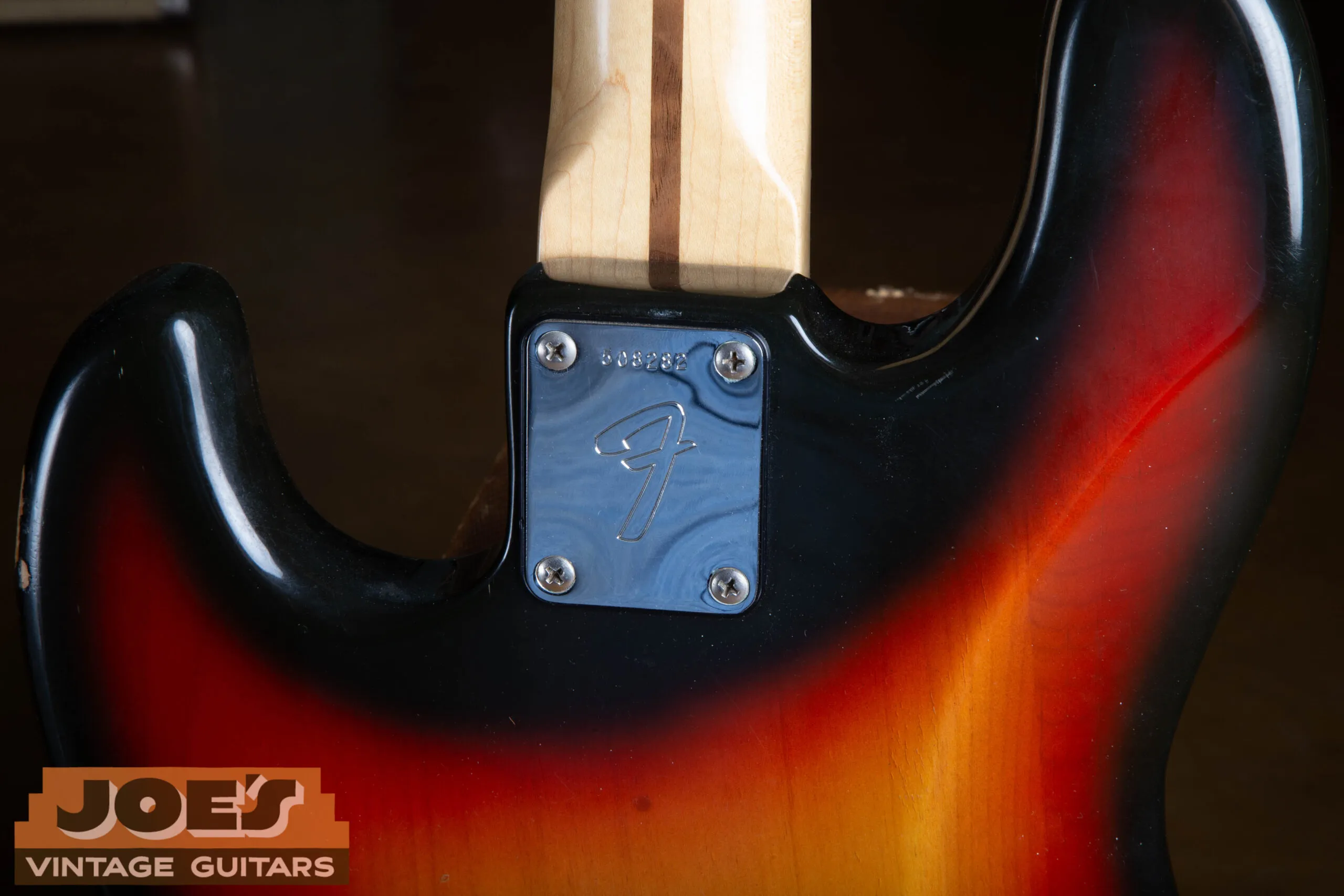 Original 4-bolt neck plate of the 1973 Fender Jazz Bass with the period-correct Fender stamping and serial number