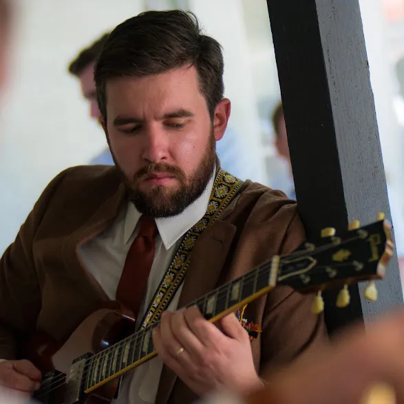 Joe Dampt playing a Gibson guitar