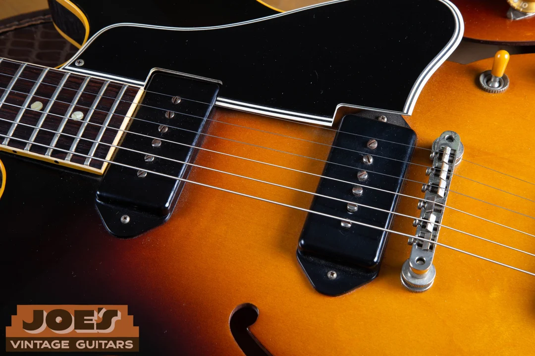 Black plastic ES-330 P-90 covers with mounting ears at both ends