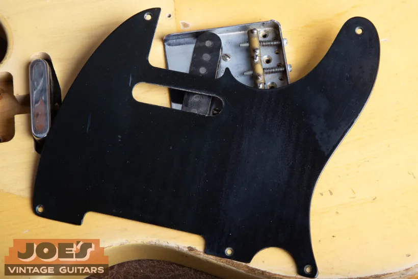 Original black phenolic pickguard lifted from a 1952 Fender Telecaster