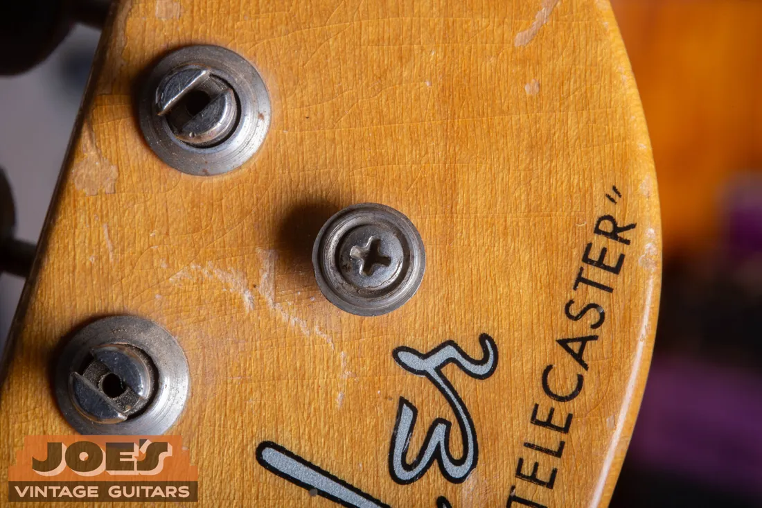 A round string guide on a vintage Fender Telecaster headstock, used before mid-1956