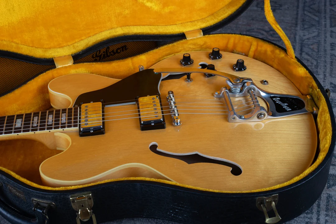 Bright chrome bridge and pickup covers on a natural 1969 Gibson thinline guitar