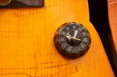 Black ridged prewar Gibson control knob with a metal pointer
