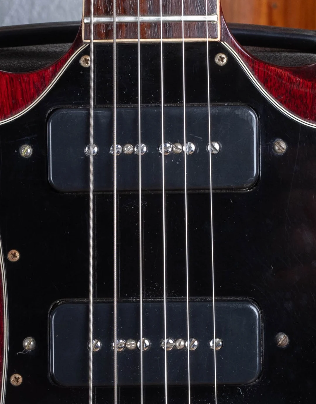 Two black soapbar P-90 pickups in a large SG Special pickguard
