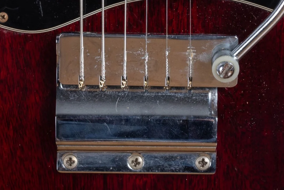 Short Maestro Vibrola mounted behind a lightning-bar bridge on a vintage Gibson SG Junior