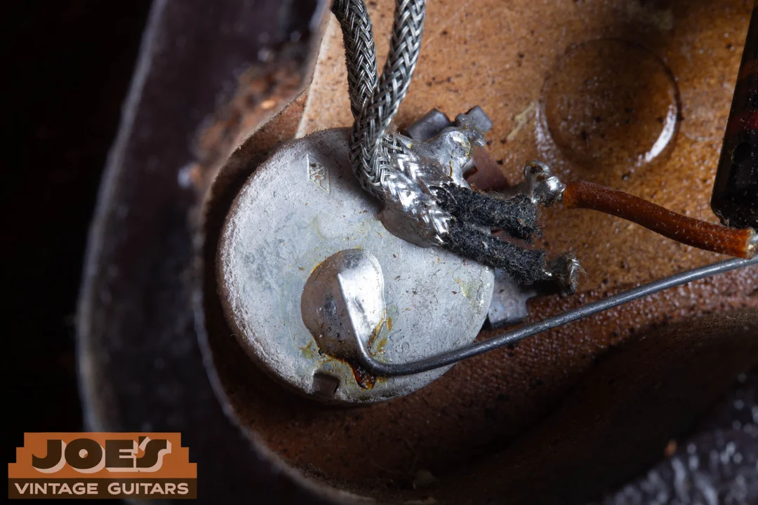 Back of a vintage Gibson Centralab pot with CRL diamond trademark, USA marking, braided wires and solder joints