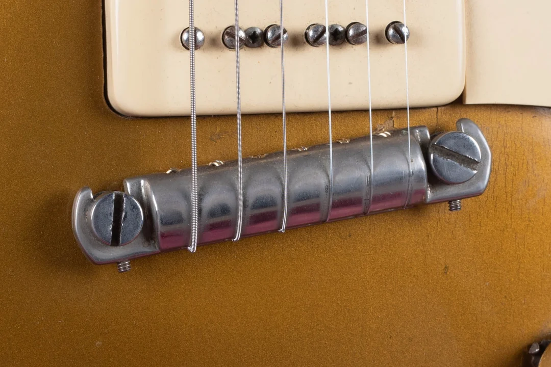 Close-up of a smooth one-piece Gibson wrapover bridge and tailpiece