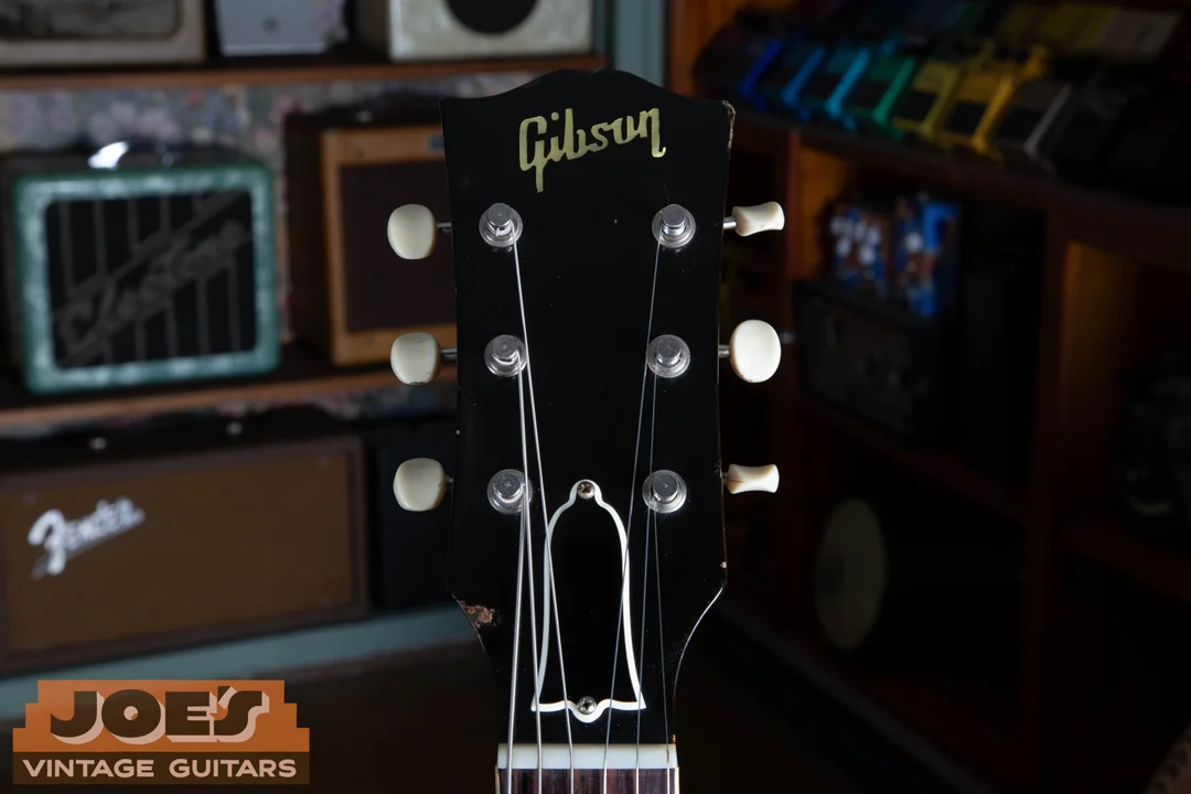 Unbound black ES-330 headstock with the Gibson logo and no crown inlay