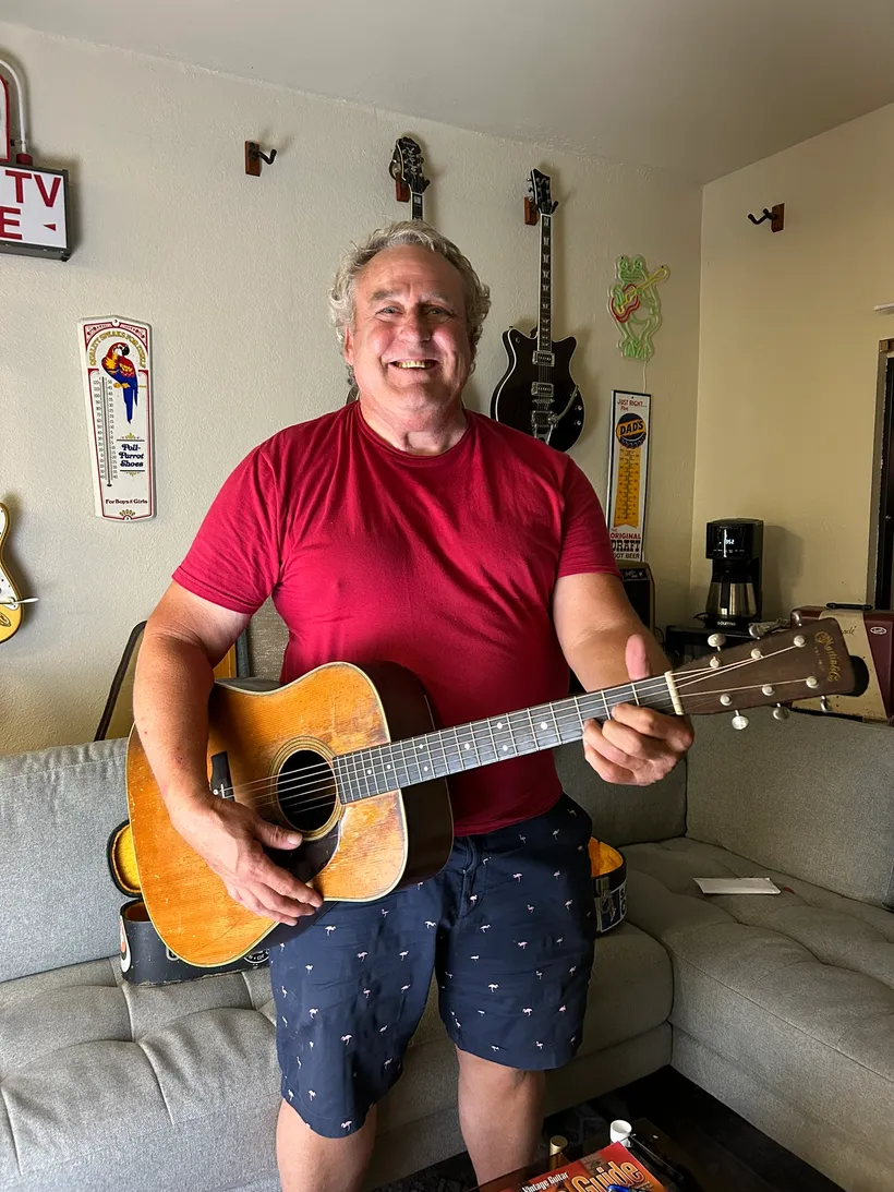Steve Minnich holding the 1955 Martin D-28 his father bought new