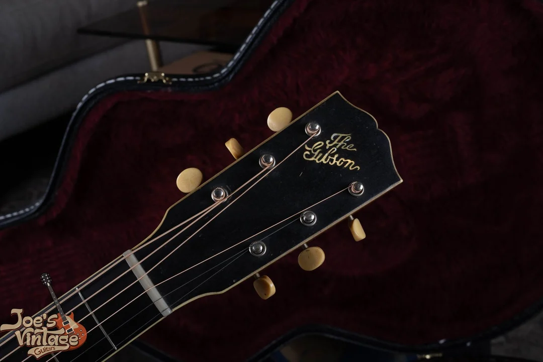 Vintage Gibson L-4 headstock with The Gibson in slanted pearl script