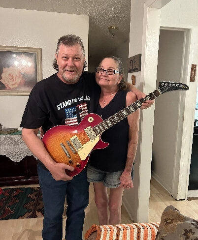 Couple receiving free guitar valuation