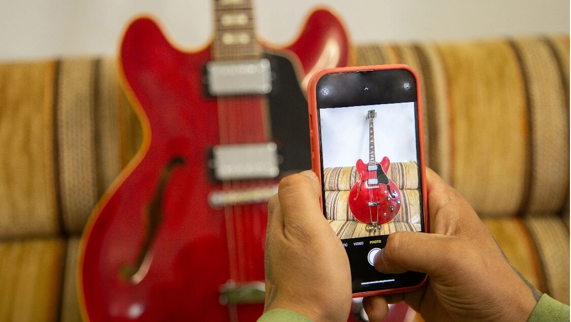 Man taking photo of cherry Gibson ES-335